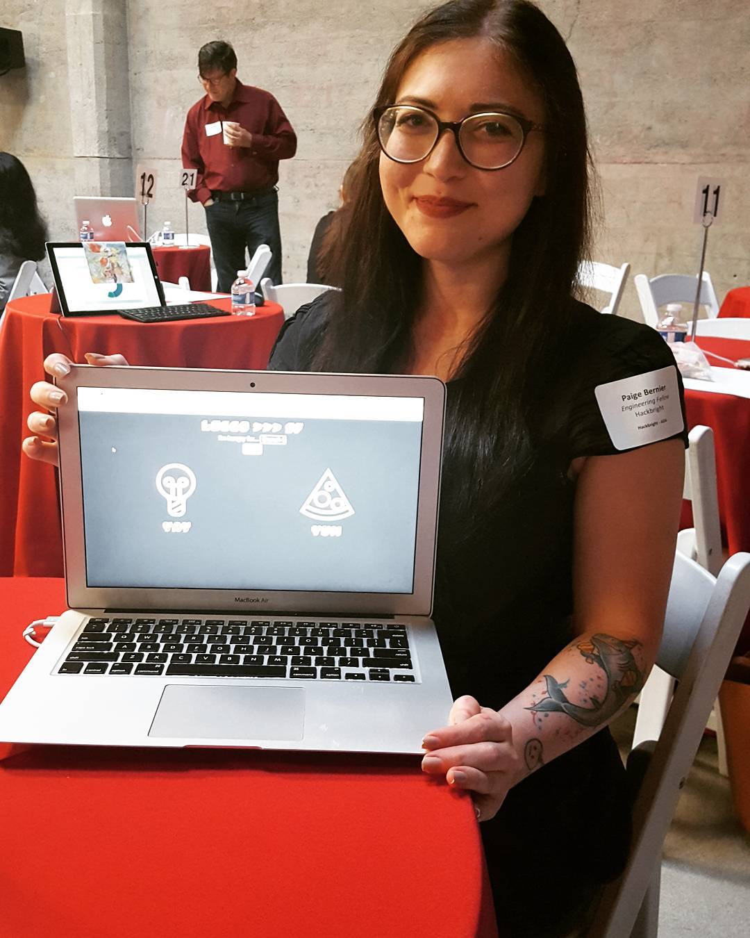 photo of paigerduty at Hackbright's graduation demo'ing her final project web app